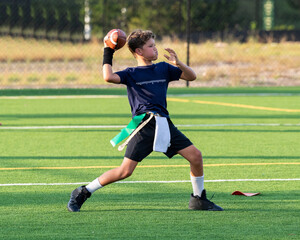 Young athletic boy playing in a flag football game