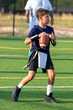 © Joe - Young athletic boy playing in a flag football game
