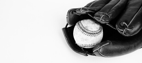 Wall Mural - Old baseball in ball glove close up, vintage texture of equipment in black and white with copy space.