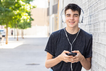 Sticker - teenage boy with mobile phone and headphones on the street