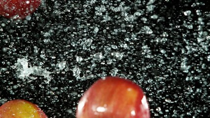 Aufkleber - Super slow motion of whole apples hitting in the air with water splashes. Filmed on high speed cinema camera, 1000 fps.