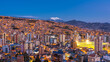 La Paz, Bolivia, panoramic view of cityscape and Illimani Mountain at dusk.