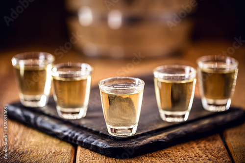 small dose glasses, high quality distilled alcohol. Brazilian cachaça (called pinga), drip, vodka, white rum, spirits, ozo, sake or cognac.