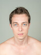 © Ranta Images - Portrait of handsome shirtless man against white background