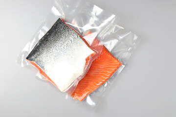 Salmon fillets in a vacuum package. Sous-vide, new technology cuisine. Selective focus, copy space