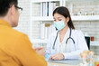 © DG PhotoStock - Asian specialist doctor talking to a patient in doctor office in hospital. Patient worried about his sickness and influenza come to a doctor and taking examination in hospital. Healthcare concept.