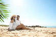 © New Africa - Happy young couple on beach near sea. Honeymoon trip