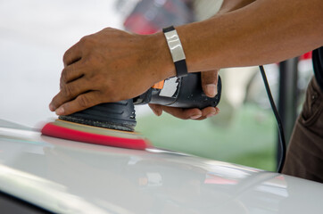 Wall Mural - Man hands holding the work tool polish the car.Buffing and polishing car. Car detailing.