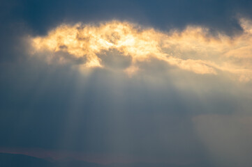 Wall Mural - the sun's rays breaking through the clouds