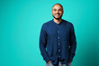 © fotofabrika - Portrait of a dark-skinned cheerful smiling man against turquoise background