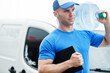 © AS Photo Family - Delivery man with clipboard in front cargo van delivering bottles of water.