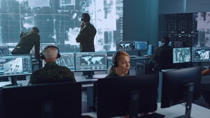 Fototapete - Military Surveillance Team of Officers Locked a Target on a Vehicle from a Satellite and Monitor it on a Big Display in Office for Cyber Operations for Managing Security and Army Communications. 