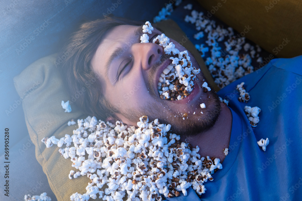 Happy movie fan with a full mouth of a popcorn