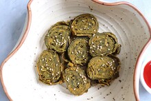 Alu Vadi Or Patra Or Colocasia Leaves Roll Is A Popular Indian Steamed Snack. Paatra Made Using  Or Taro Leaves, Coconut, Gram Flour And Spices. Garnished With Sesame Seeds. Copy Space.