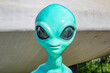 Turquoise plastic toy alien with big black eyes