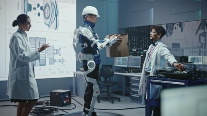 Poster - In Development Laboratory: Engineers Work on a Robotic Exoskeleton with a Person Testing it by Trying to Lift Heavy Cardboard Box. Designing Wearable Exosuit to Help Hard Labor Warehouse Workers