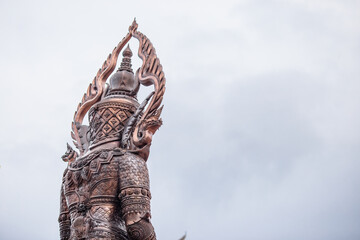 Blurred abstract background of sculptures seen at temples or religious tourist sites (Phaya Nak, Buddha statues) within Wat Pa Phu Kon in Udon Thani, Thailand