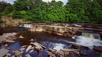 Wall Mural - A scenic view of the cascading waterfalls of the River Swale at Richmond,North Yorkshire,England, UK