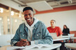 © Jacob Lund - Portrait of smiling boy in university classroom