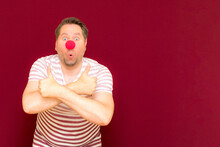 The Happy Surprised Charming Trendy And Smiling Man On Red Nose Day Or April Fools Day.Man Shows Thumb Up