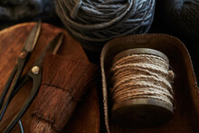 Wool Yarns, Scissors, Twine, And Broom