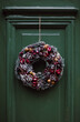 © Duet Postscriptum/Stocksy - Christmas wreath of branches on a green door
