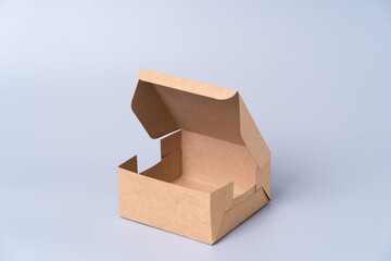 Wall Mural - Brown paper box for food package. carton on a gray background.