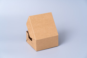 Wall Mural - Brown paper box for food package. carton on a gray background.