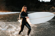 © Caleb Gaskins/Stocksy - Girl with surfboard