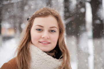 Smiling blonde girl in a winte park