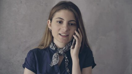 Wall Mural - young woman talking to the mobile phone