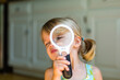 © Sarah Rypma - Young girl's eye close up through a magnifying glass