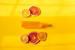 Flat lay with bottle of spay and dry oranges. Mono color. Composition with organic cosmetic and window llight.