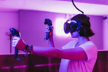 Girl in a purple VR room playing games.