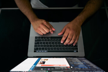 Hands of ethnic man typing on keyboard