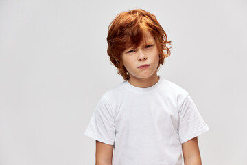 Sticker - Displeased red-haired boy squints his eyes white t-shirt incredulous look