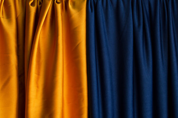 dark yellow and blue draped curtains.empty space for design