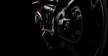 Side View Of Red Sports Motorcycle In A Spotlight On A Black Background