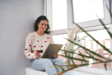 Woman with credit card and tablet buying in internet. Shopping online