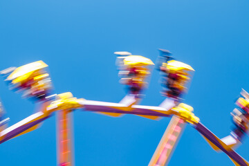 Wall Mural - Extreme ride in motion in amusement park at sunny day