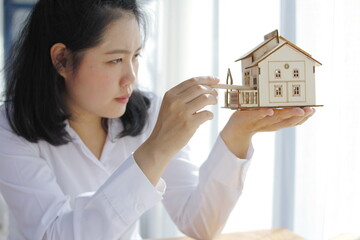 Female architect working on hand having home business concept model