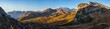 © wildman - Sunny colorful autumn alpine Dolomites rocky mountain scene, Sudtirol, Italy. Peaceful view from Falzarego Pass. Snowy Marmolada massif and Glacier in far. High resolution ultra wide panorama.