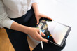 © diignat - Business woman working with tablet in modern office wearing white shirt black pants