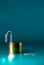 Image Of Padlock On A Blue Background. Lock Is Open.