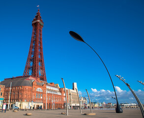 Blackpool seafront and promenade with a blue cloudless sky including the Blackpool Tower, Lancashire, UK