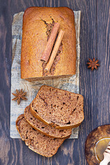 Poster - Gingerbread and honey loaf cake with cinnamon and anise on wooden background. Rustic style.