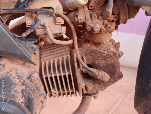 Obraz Dibond Old motorcycle engine with oil and dirt stains.