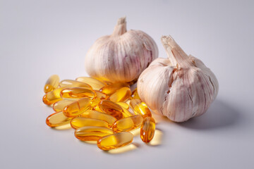 Wall Mural - Garlic with cod liver oil on white background