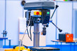 Vertical drilling machine close-up. Drill press with a vise. Equipment for Metalworking. Drilling equipment in the workshop. Machine for drilling holes in metal parts.