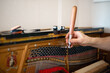 Technician, tuning a piano. Piano tuning is the act of adjusting the tension of the strings of an acoustic piano so that the musical intervals between strings are in tune.